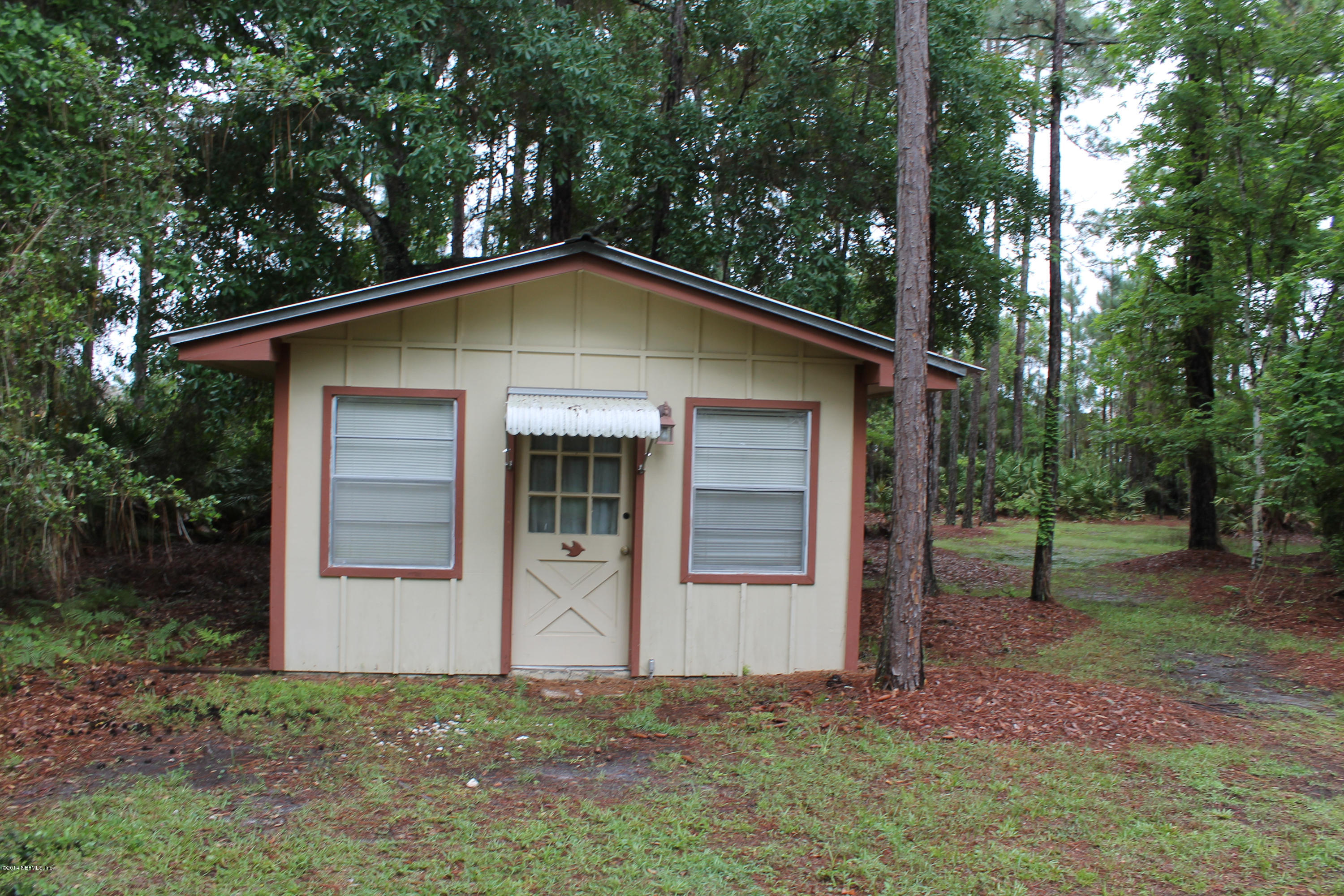 5700 Datil Pepper Road St. Augustine, FL 32086 - Photo 5 of 17 a front view of a house with garden