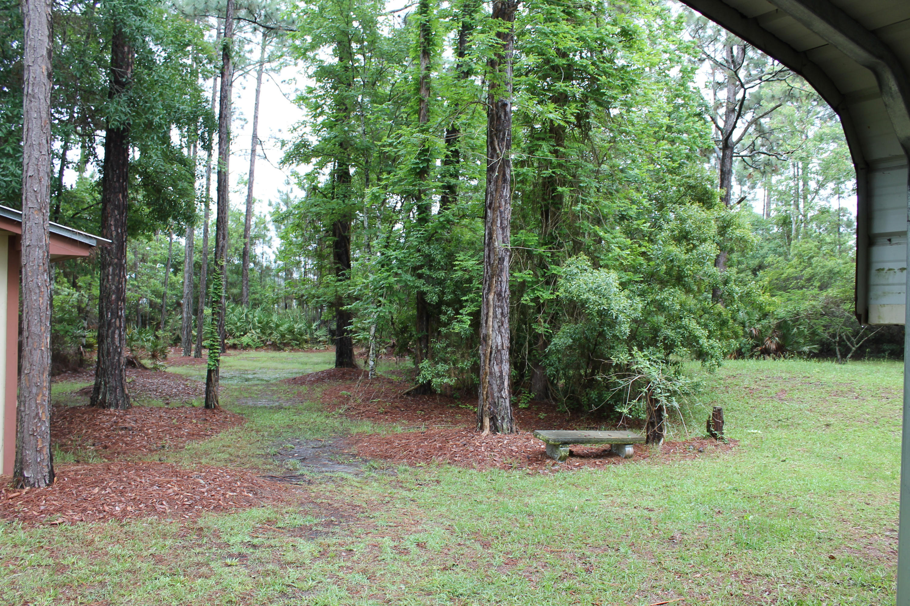 5700 Datil Pepper Road St. Augustine, FL 32086 - Photo 7 of 17 a view of a backyard with large trees