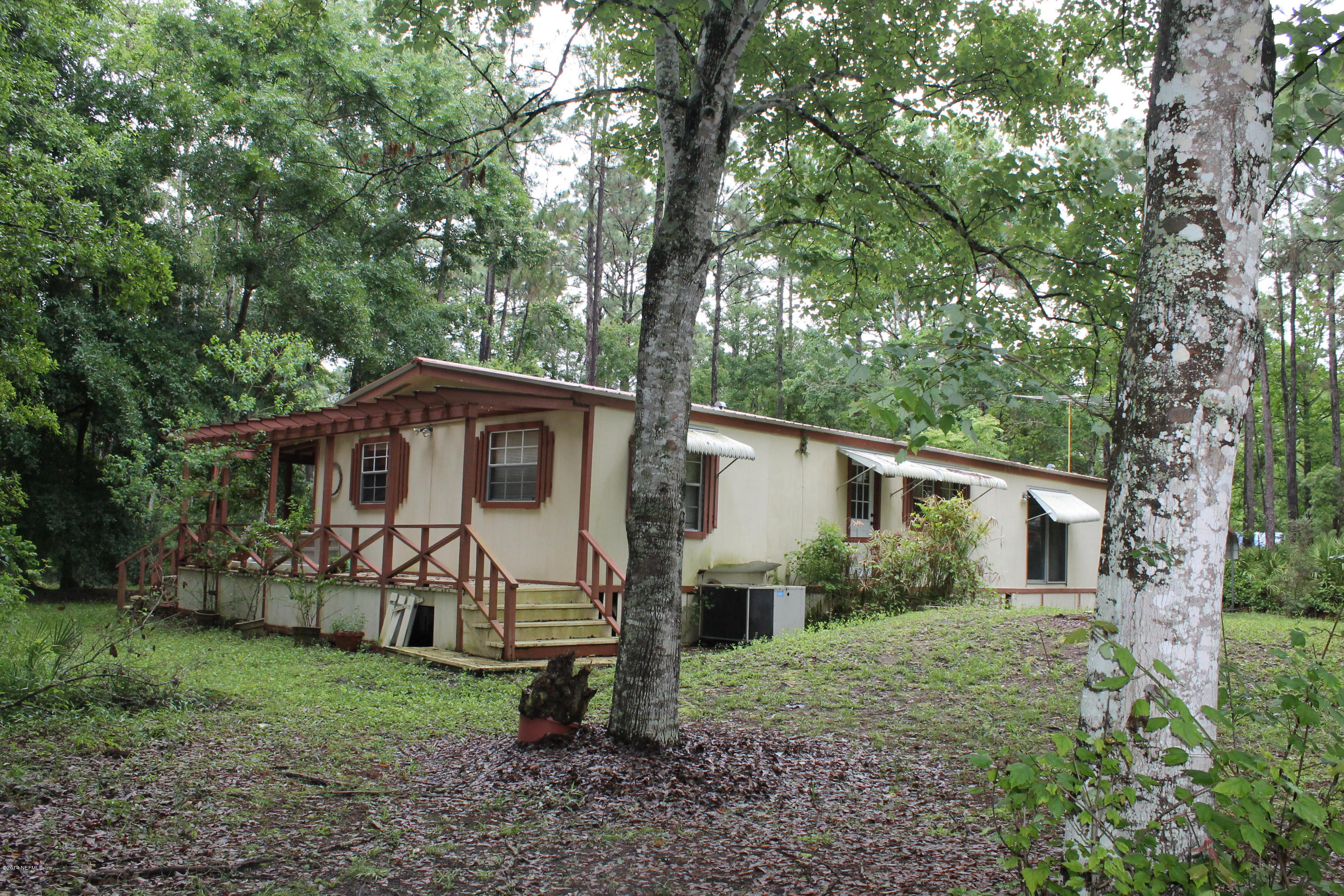 5700 Datil Pepper Road St. Augustine, FL 32086 - Photo 8 of 17 a view of a yard in front of a house with large trees