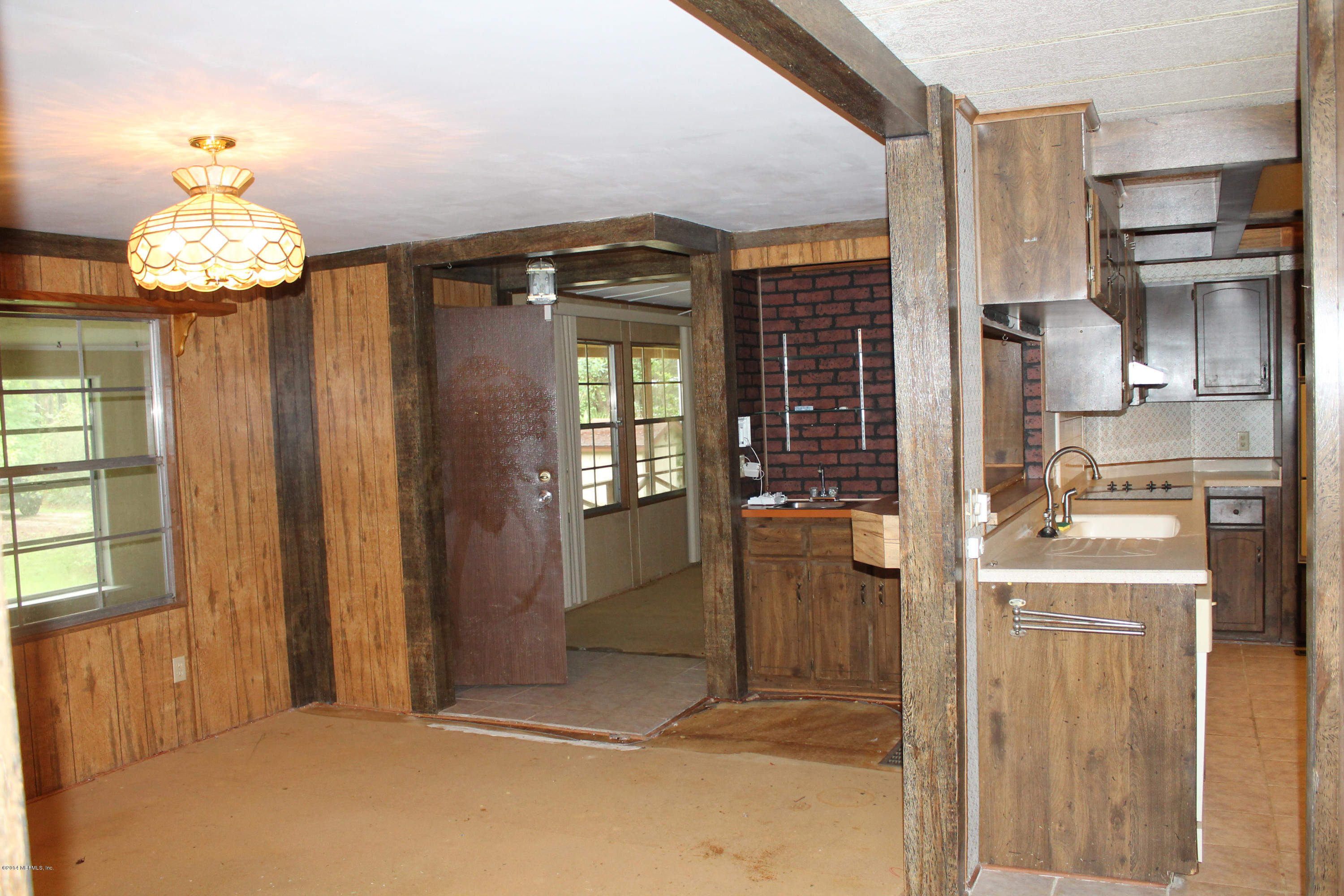 5700 Datil Pepper Road St. Augustine, FL 32086 - Photo 10 of 17 a view of a kitchen with a refrigerator cabinets and a wooden floor