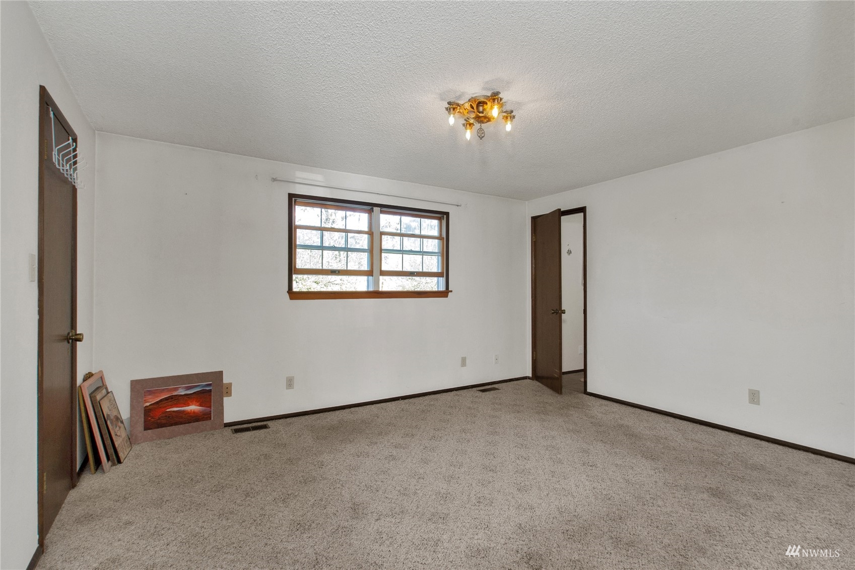 12128 Hunter Loop Road Southwest Rochester, WA 98579 - Photo 13 of 31 an empty room with windows