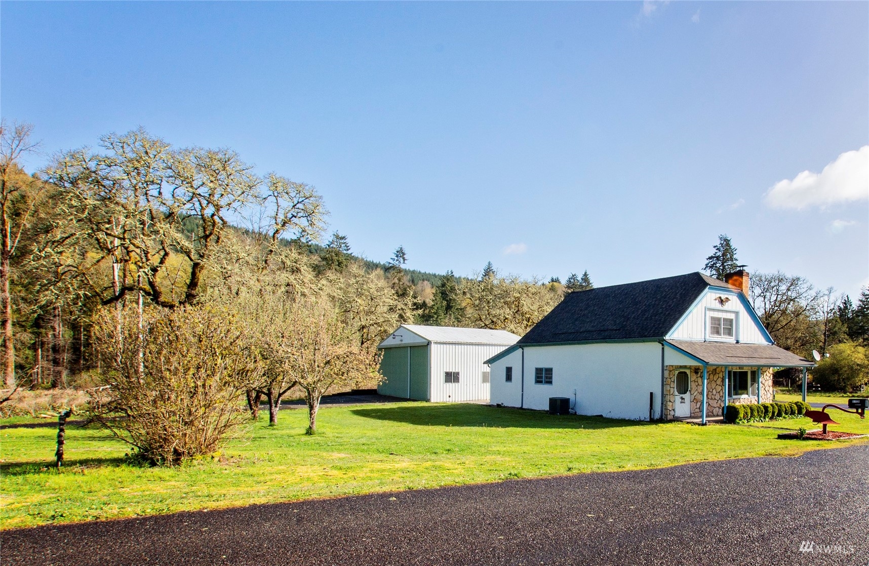 12128 Hunter Loop Road Southwest Rochester, WA 98579 - Photo 23 of 31 a front view of a house with a yard and garage