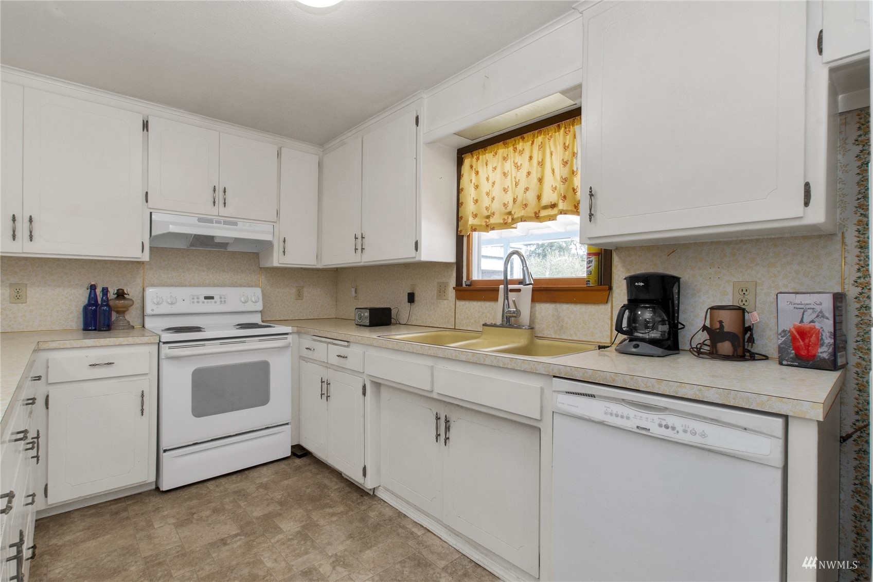 12128 Hunter Loop Road Southwest Rochester, WA 98579 - Photo 3 of 31 a kitchen with white cabinets and white appliances