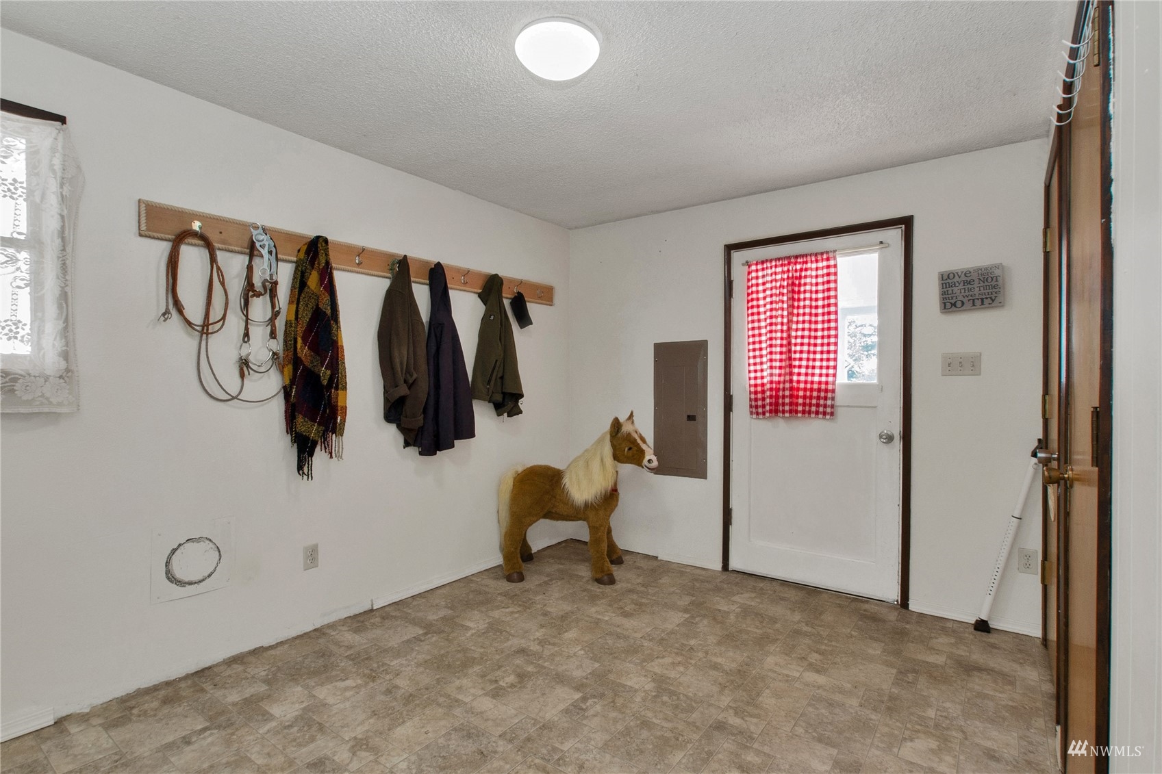 12128 Hunter Loop Road Southwest Rochester, WA 98579 - Photo 7 of 31 a view of a room with window and couch