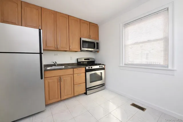 a kitchen with granite countertop white cabinets and white appliances