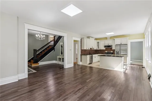a view of kitchen with wooden floor and electronic appliances