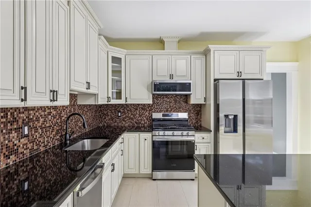 a kitchen with a refrigerator sink and stove