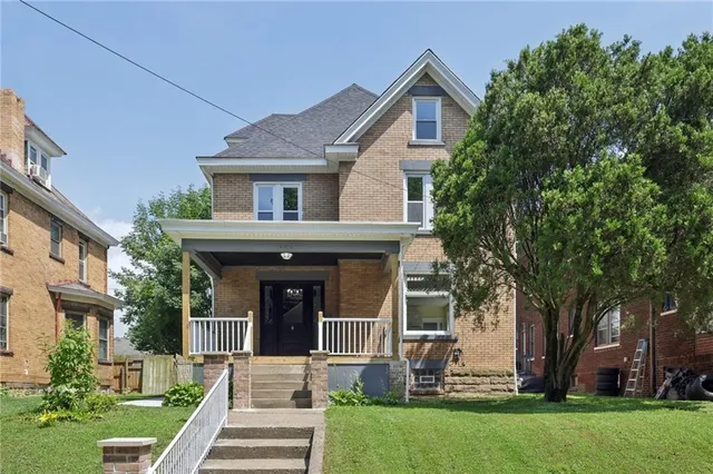 a front view of a house with garden