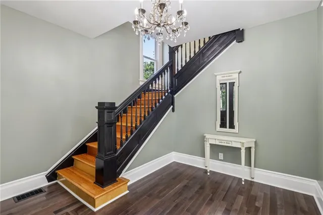 a view of entryway and hall with wooden floor