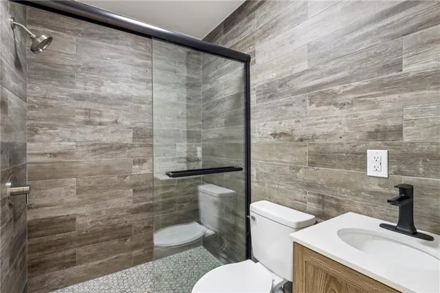 a bathroom with a toilet and a shower