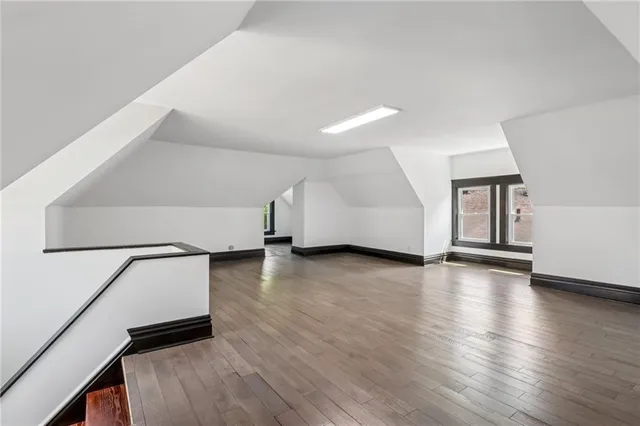 a view of a room with wooden floor