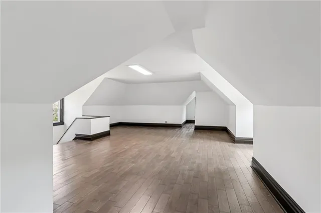a view of a brick house with a door and wooden walls
