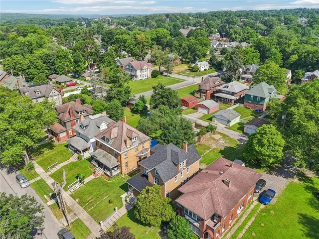 an aerial view of a house with a yard