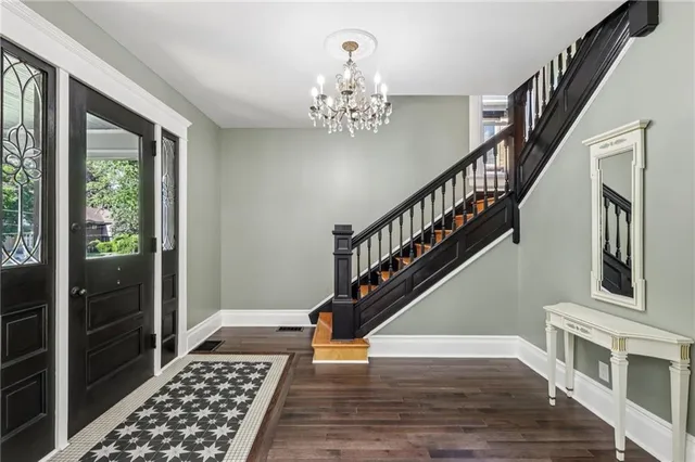 a view of entryway and hall with wooden floor