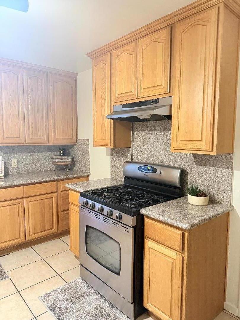 440 West 7th Street Gilroy, CA 95020 - Photo 4 of 6 a kitchen with granite countertop a stove sink and cabinets