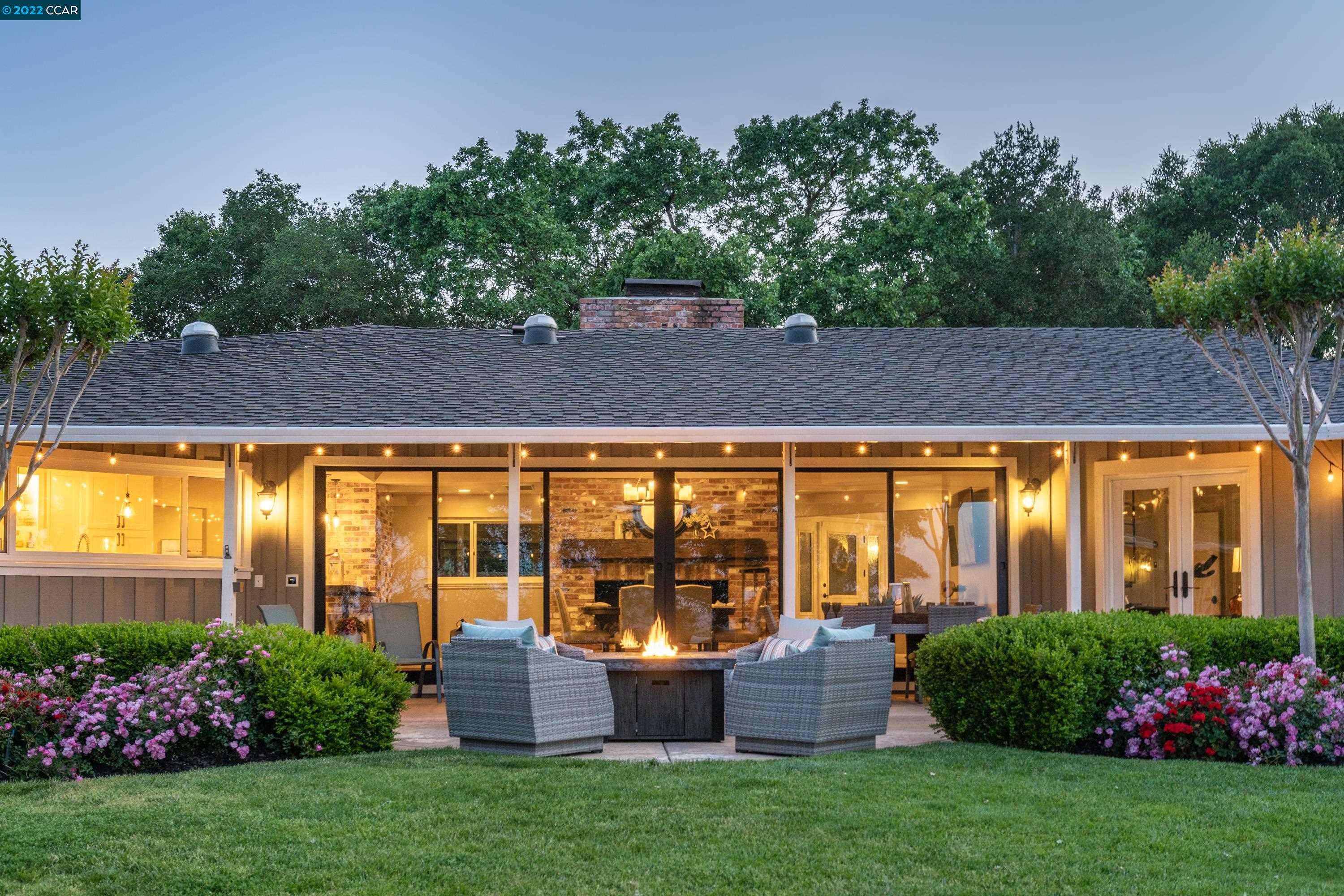 a front view of house with yard and outdoor seating