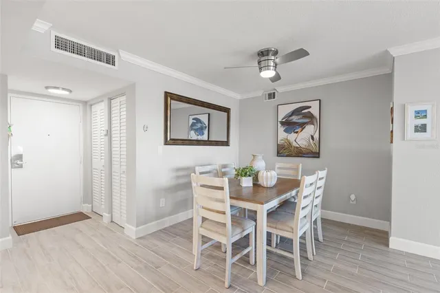 a spacious bedroom with a bed and wooden floor