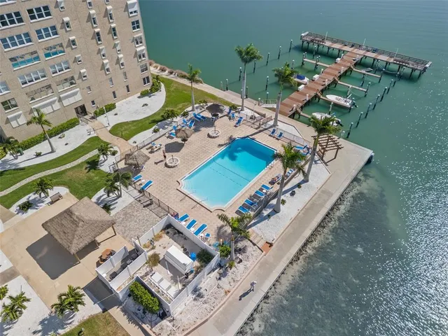 a view of swimming pool with outdoor seating and lake view