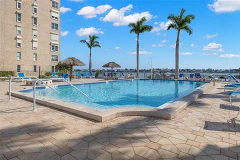 a view of a patio with a table and chairs under an umbrella
