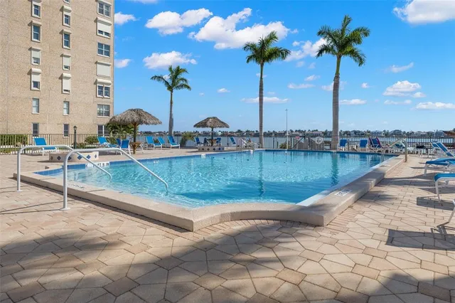 a view of a patio with a table and chairs under an umbrella