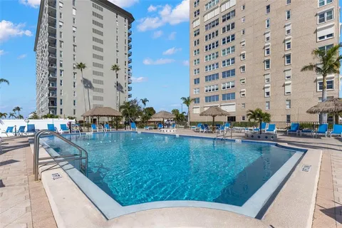 a reading room with furniture and a potted plant