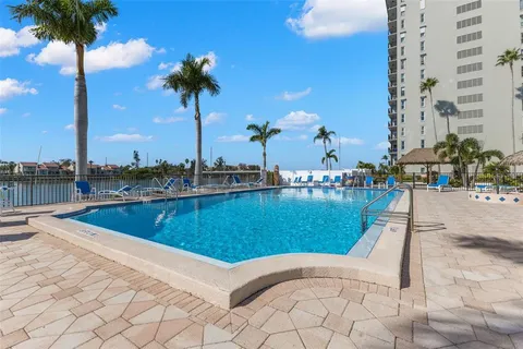 a spacious bedroom with a bed and a flat screen tv