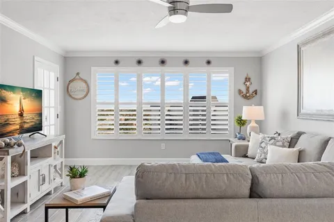a living room with furniture and view of kitchen
