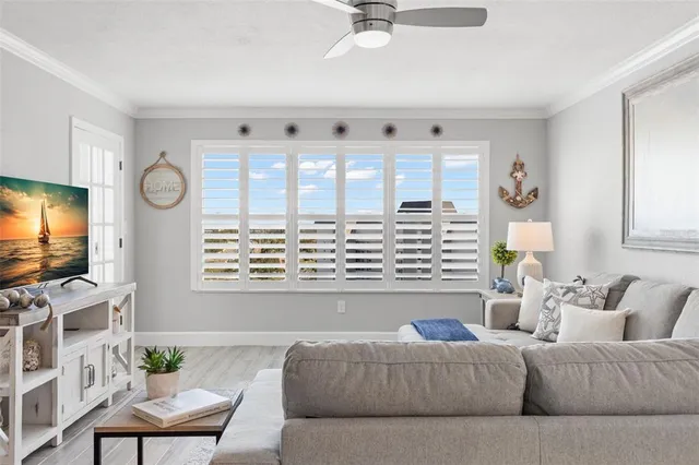 a living room with furniture and view of kitchen