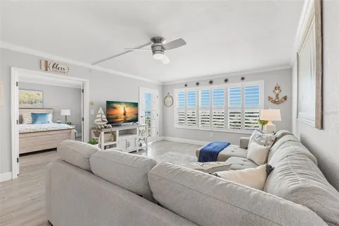 a kitchen with granite countertop a refrigerator and white cabinets