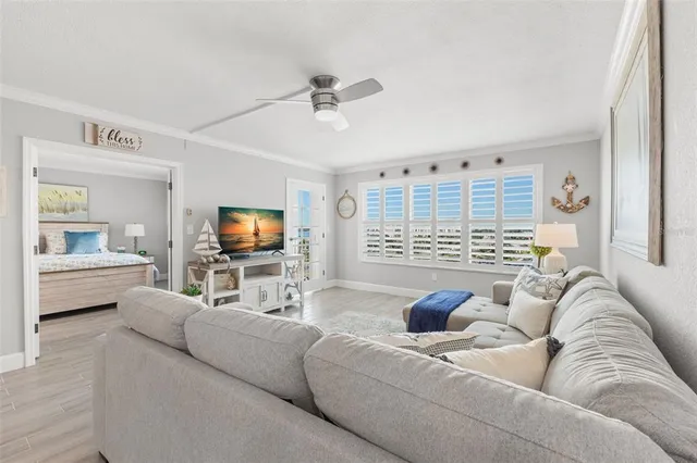 a kitchen with granite countertop a refrigerator and white cabinets