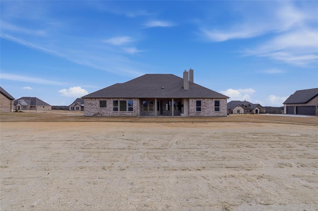 810 Vly Rdg Road Van Alstyne, TX 75495 - Photo 36 of 39 Rear view of property featuring a chimney, a residential view, brick siding, and a patio area