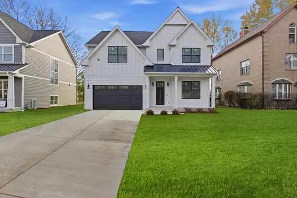 a front view of a house with a garden and yard