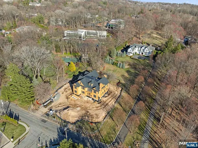 an aerial view of a house with a yard