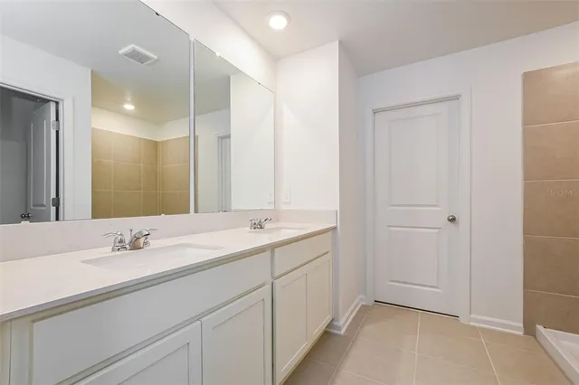 a bathroom with a double vanity sink and mirror