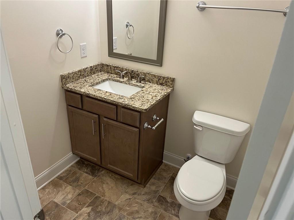 202 Gamel Road Dallas, GA 30157 - Photo 12 of 34 a bathroom with a granite countertop toilet and a sink