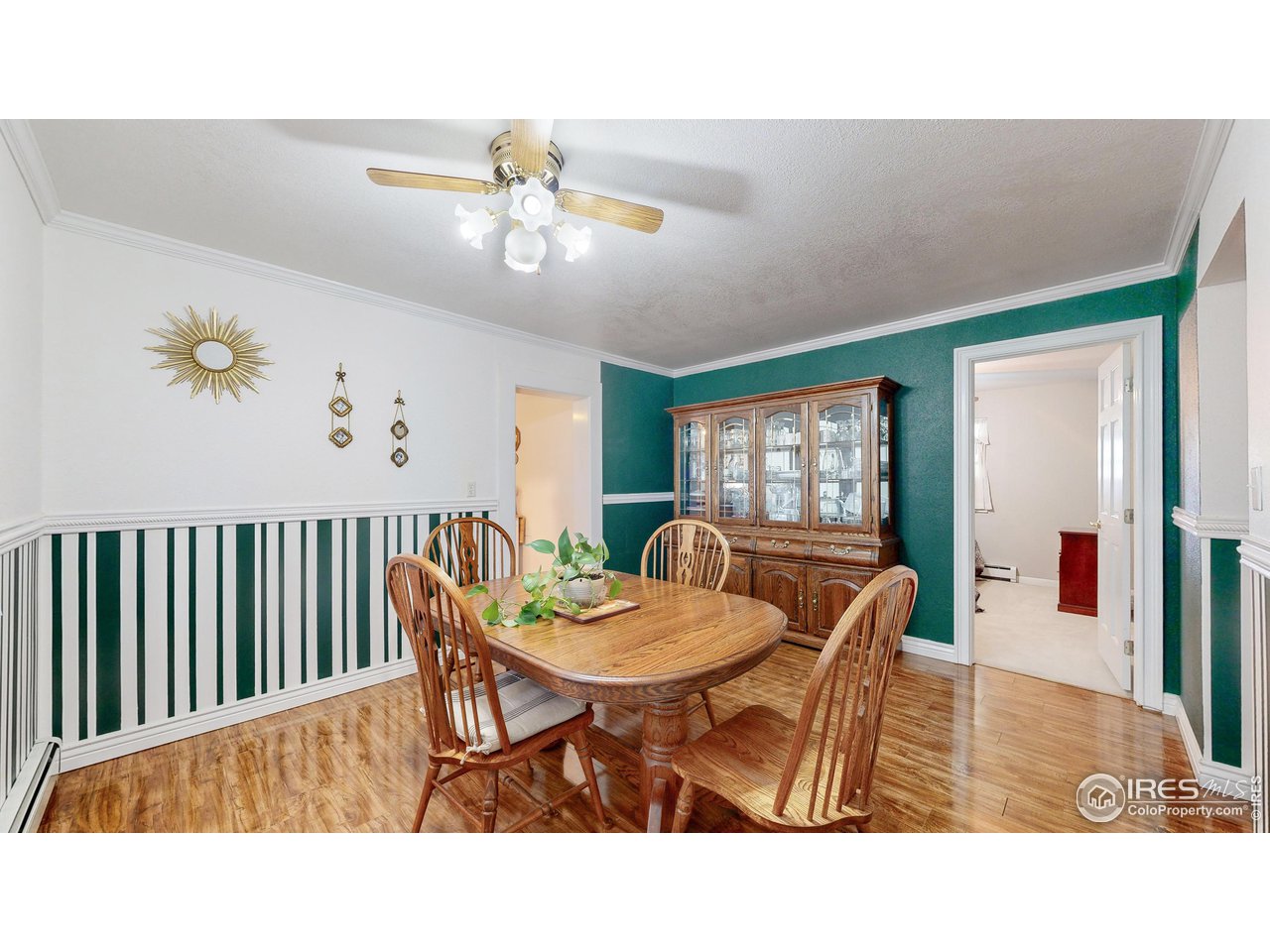 12775 East County Line Road Longmont, CO 80504 - Photo 11 of 40 a dining room with wooden floor and a chandelier