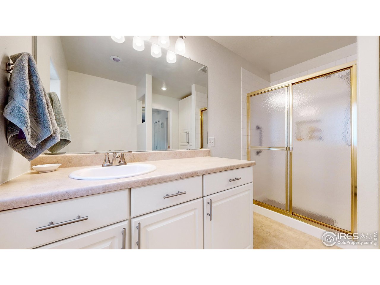 12775 East County Line Road Longmont, CO 80504 - Photo 18 of 40 a bathroom with a sink double vanity and a mirror