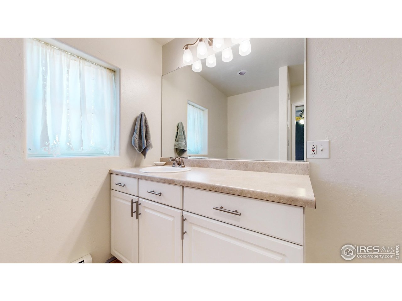 12775 East County Line Road Longmont, CO 80504 - Photo 19 of 40 a bathroom with a sink a vanity and a mirror