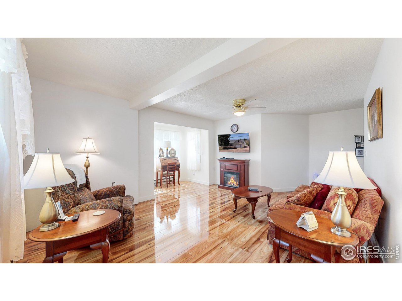 12775 East County Line Road Longmont, CO 80504 - Photo 4 of 40 a living room with furniture a dining table and a lamp