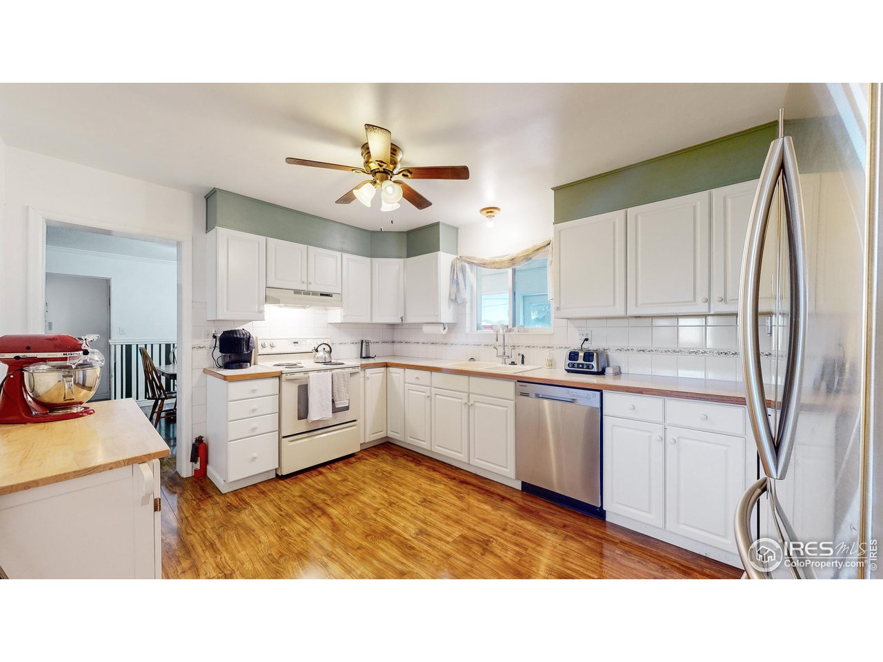 12775 East County Line Road Longmont, CO 80504 - Photo 9 of 40 a kitchen with a sink window and cabinets