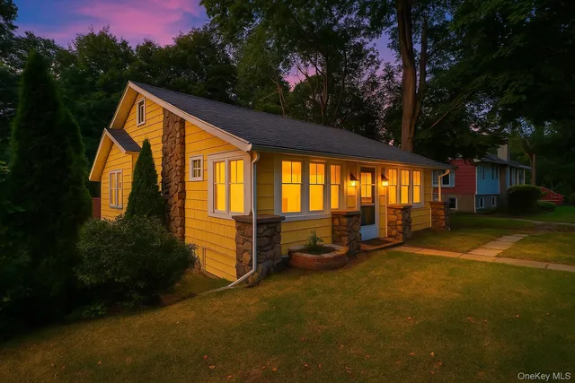 a backyard of a house with garden and outdoor seating