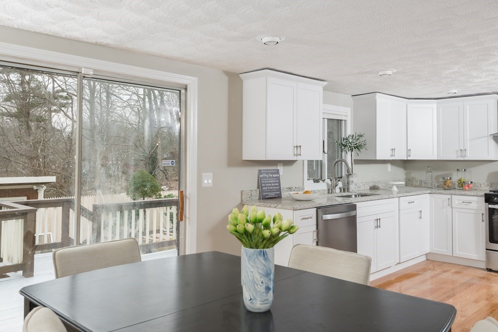 299 Center Street Randolph, MA 02368 - Photo 12 of 32 a kitchen with counter top space and wooden floor