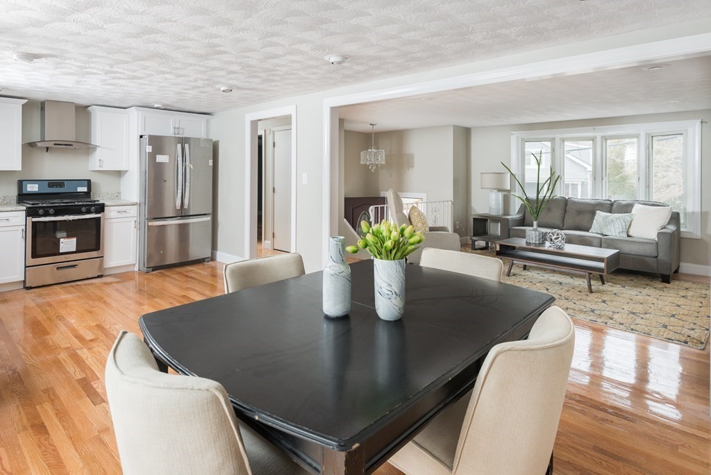 299 Center Street Randolph, MA 02368 - Photo 13 of 32 a kitchen with a table chairs and refrigerator