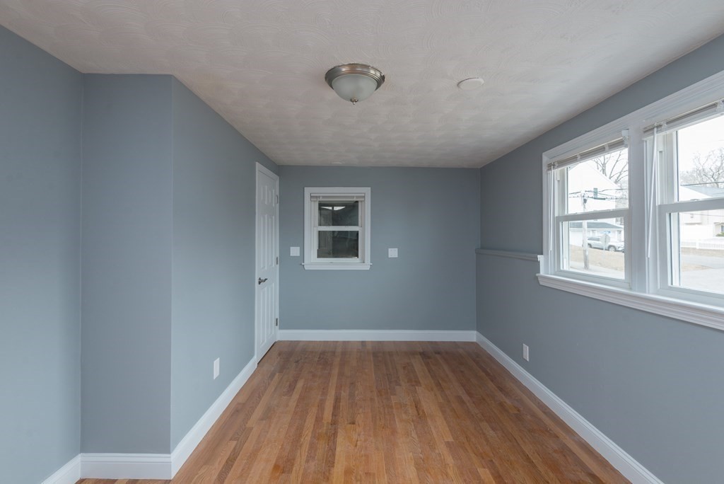 299 Center Street Randolph, MA 02368 - Photo 16 of 32 an empty room with wooden floor and windows