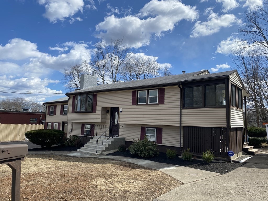 299 Center Street Randolph, MA 02368 - Photo 2 of 32 a front view of a house with garden and patio