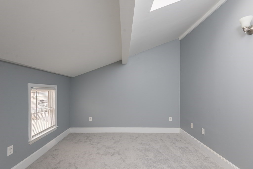 299 Center Street Randolph, MA 02368 - Photo 22 of 32 an empty room with windows and closet