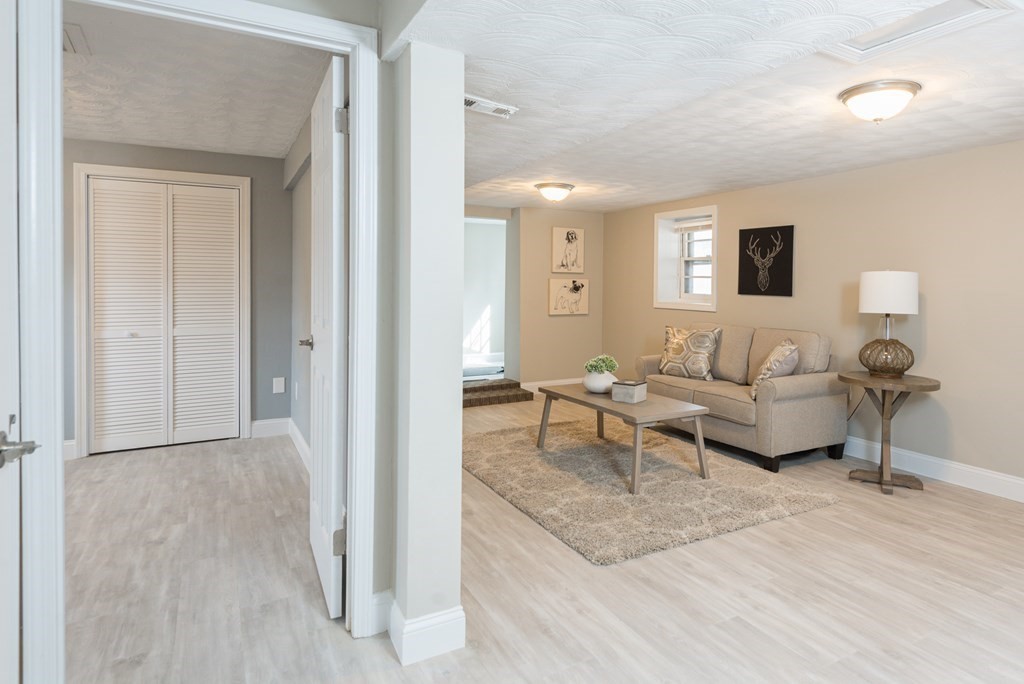 299 Center Street Randolph, MA 02368 - Photo 26 of 32 a living room with furniture and a wooden floor