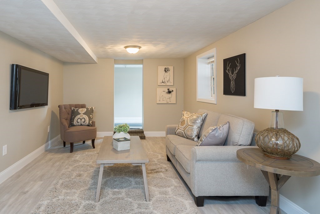 299 Center Street Randolph, MA 02368 - Photo 27 of 32 a living room with furniture and a flat screen tv