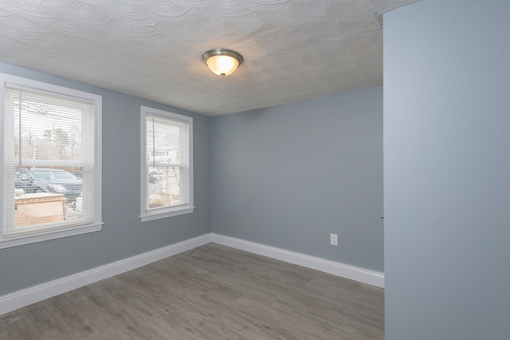 299 Center Street Randolph, MA 02368 - Photo 29 of 32 an empty room with wooden floor and windows