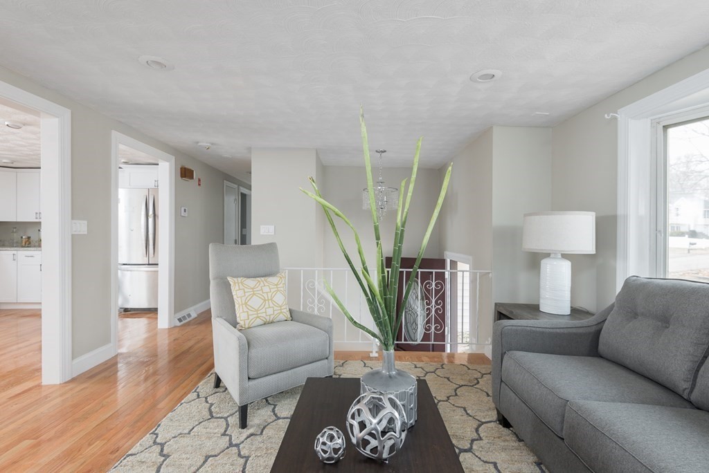 299 Center Street Randolph, MA 02368 - Photo 6 of 32 a living room with furniture and a wooden floor